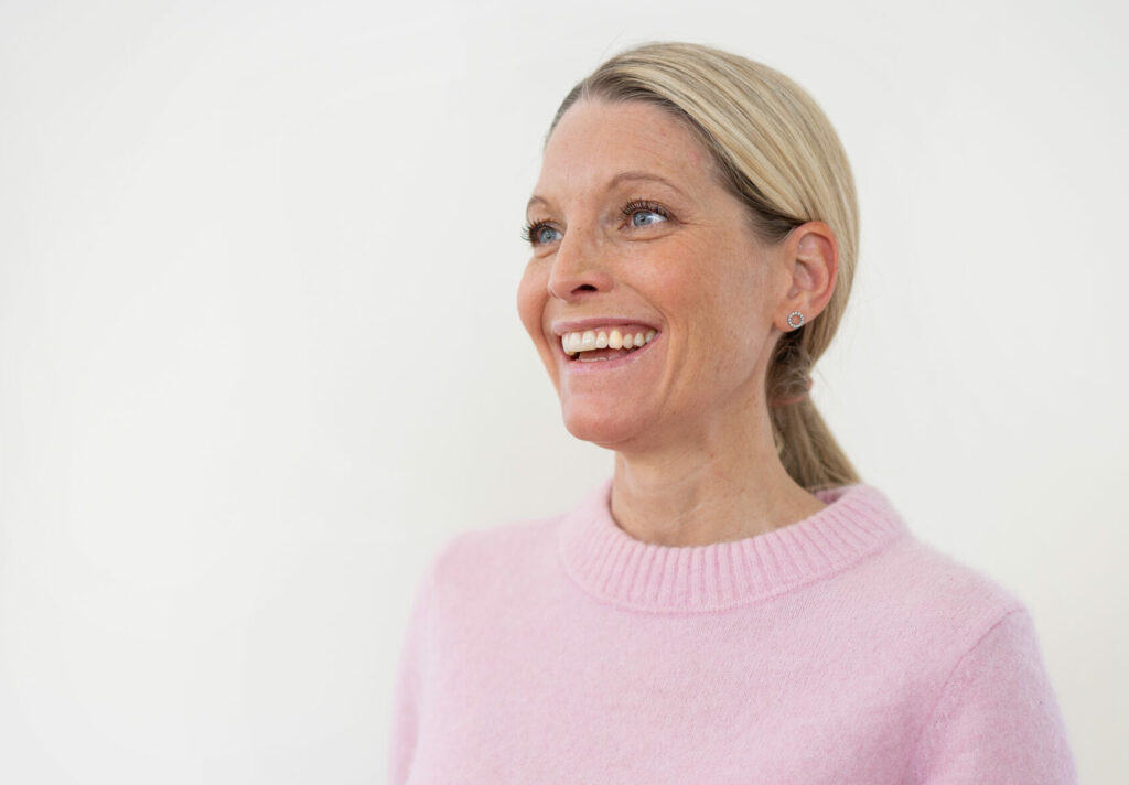 Dietitian Sofia Antonsson, smiling, wearing a pink sweater against a white background.